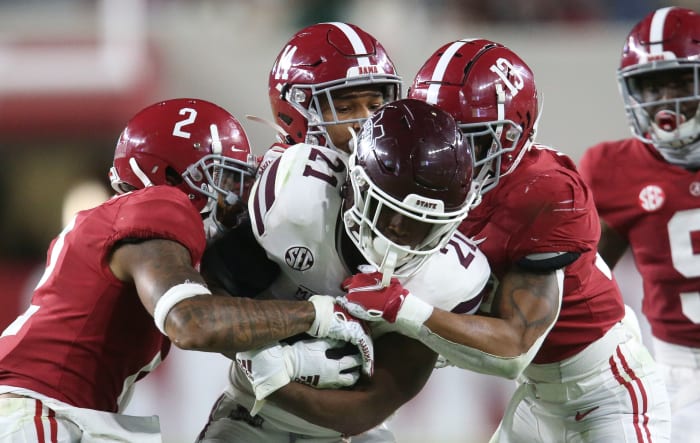 Alabama defensive back Patrick Surtain II (2), Alabama defensive back Brian Branch (14) and Alabama defensive back Malachi Moore (13) combine to tackle Mississippi State running back Jo'quavious Marks (21) at Bryant-Denny Stadium during the second half of Alabama's 41-0 win over Mississippi State.